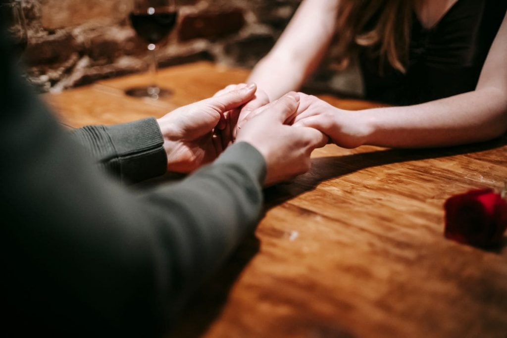 Faceless couple having date in restaurant