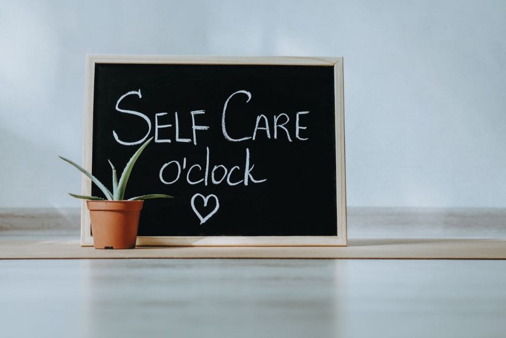 Chalkboard with self care oclock message