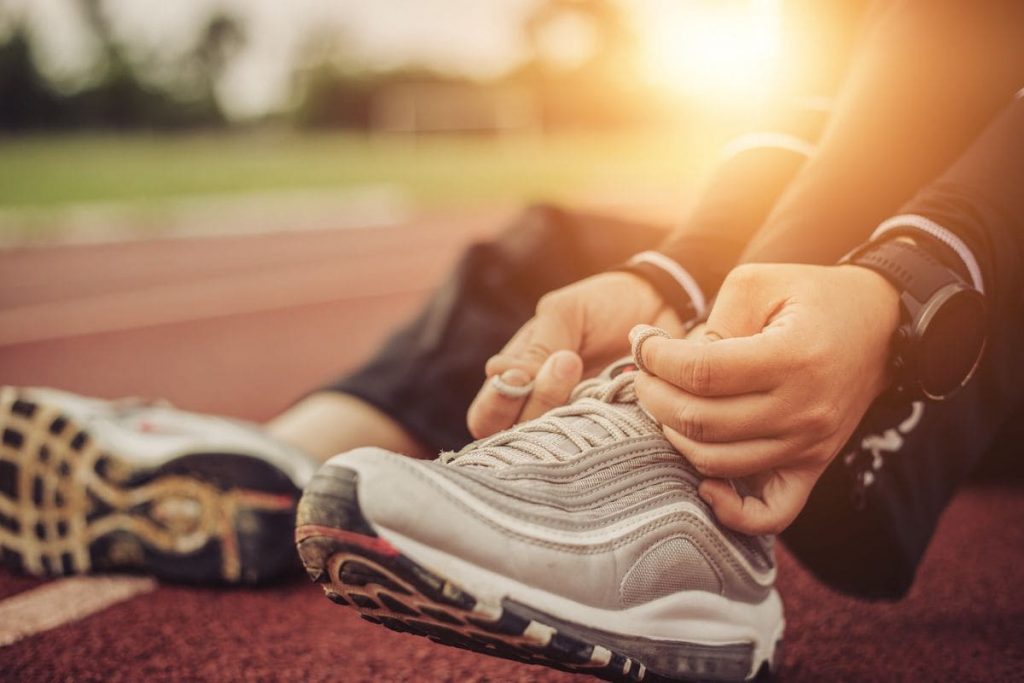 Run, A person sits on the floor and ties his sneakers