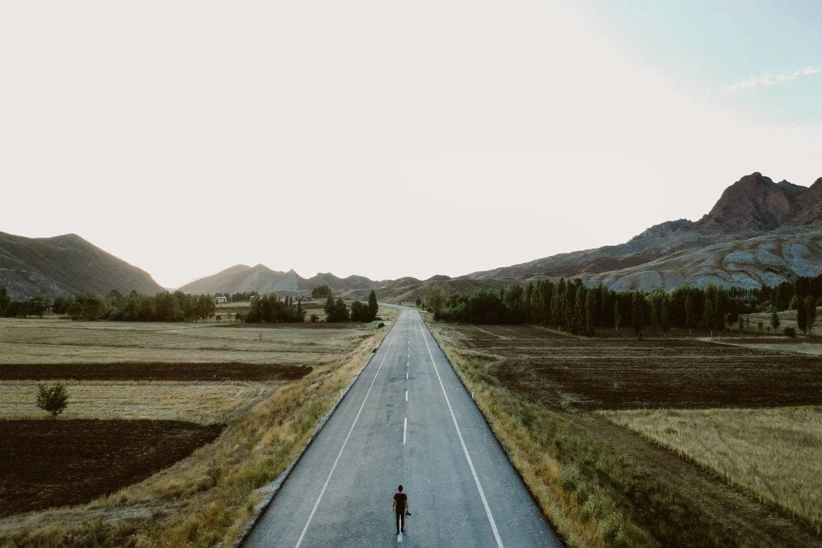 A person standing alone on a country road