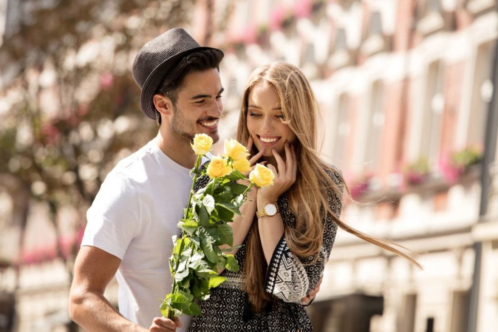 Beautiful couple with flowers dating.