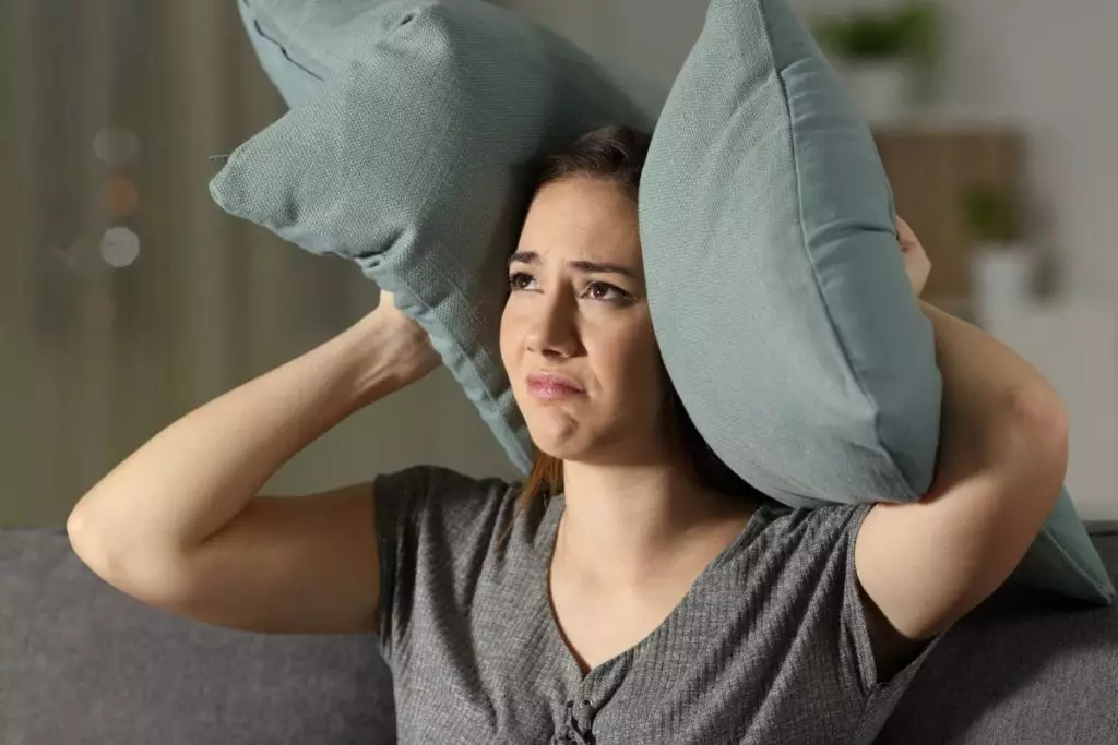 Annoyese woman suffering neighbour noise
