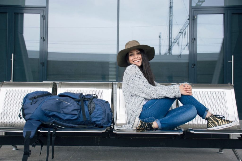 Woman travelling alone, sitting on a bench