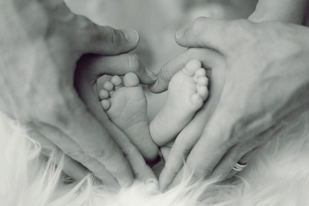 Parents hands holing baby feet