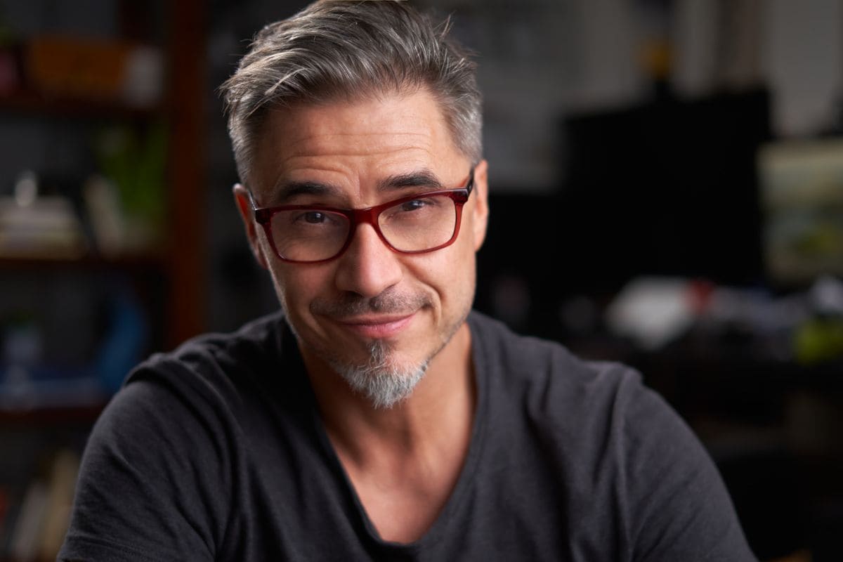 Portrait of older man with gray hair at home