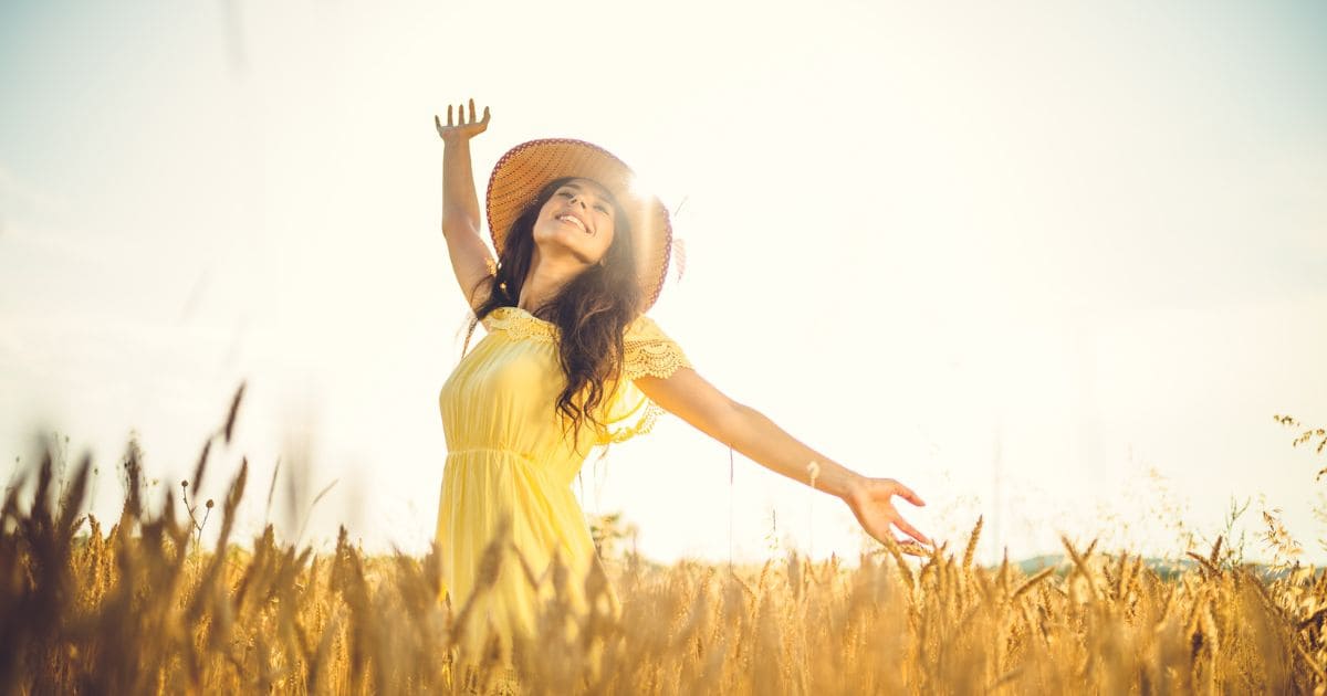 Happiness, happy woman with hat in the field