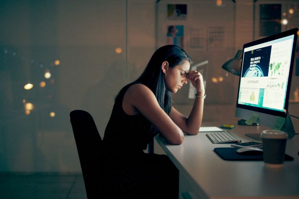 Even the most ambitious burnout, woman sitting in front of the work desk