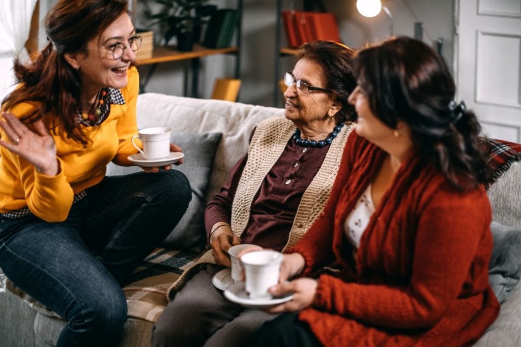 Small talk, three woman talking and having tea